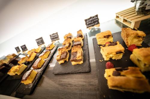 a bunch of desserts on plates on a table at HB Aosta Hotel & Balcony SPA in Aosta