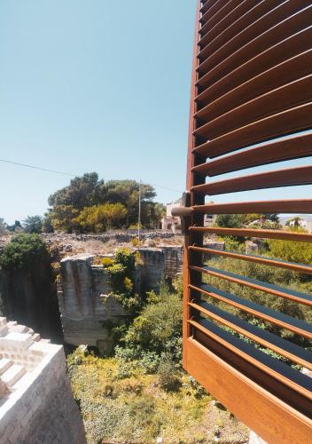 a view of a canyon through a fence at Cave Garden rooms in Favignana