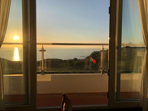 a room with a window with a view of the ocean at Silver Coast Vacation - Your Unique Inn in Lourinhã