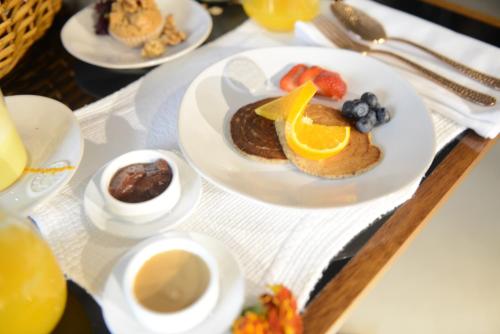 a table with plates of breakfast food on a table at Raw Culture Art & Lofts Bairro Alto in Lisbon