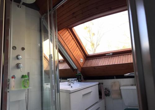 a bathroom with a sink and a window in it at La Petite Londe in Biéville-Beuville