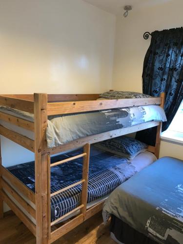two bunk beds in a room with a window at Alandene in Blackpool