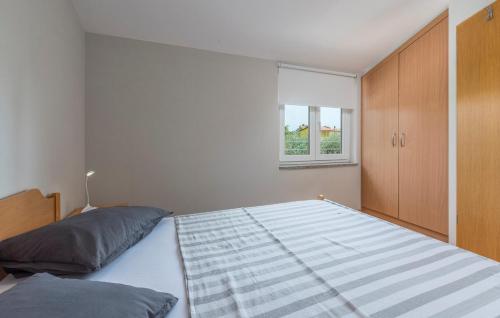 a bedroom with a large bed and a window at Apartment Green with Balcony in Nova Vas