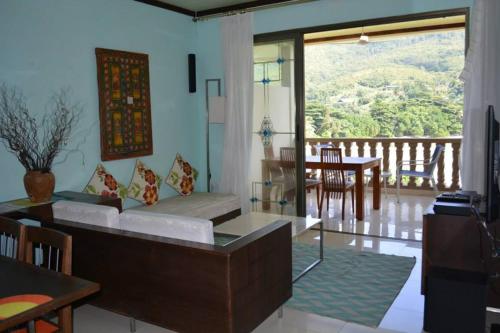 a living room with a couch and a table at Seychelles in Anse Boileau