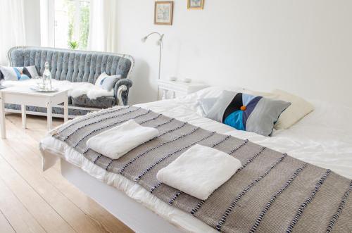 a bedroom with a bed with a blanket and a chair at Struckshus in Tønder