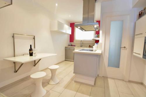 a kitchen with a counter and two stools and a sink at Saval Rits in Salou