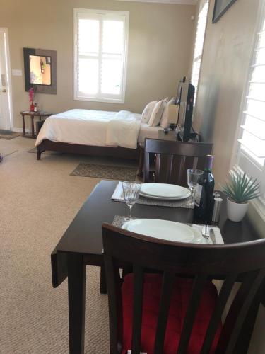 a room with a bed and a table with two chairs at Bluewaters Retreat Bachelor Unit in Vernon Bridge