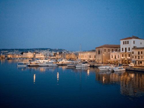 a group of boats are docked in a harbor at Constantinos Studios in Chania