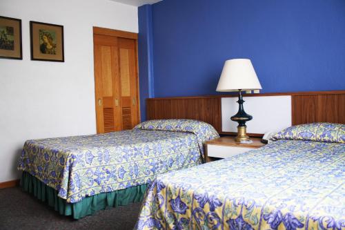 Un pat sau paturi într-o cameră la Hotel New York Ciudad de Mexico