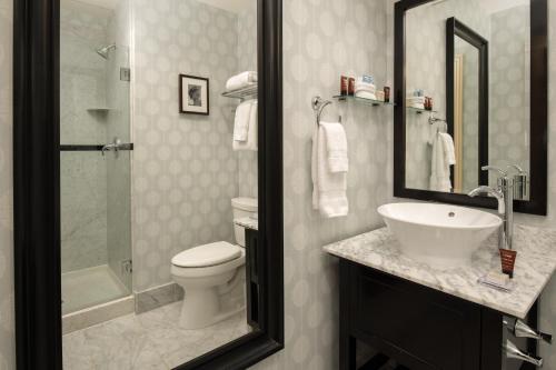 a bathroom with a sink and a toilet and a shower at Hotel Shattuck Plaza in Berkeley