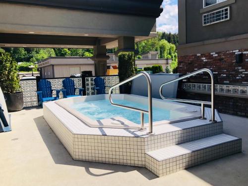 a hot tub on a patio next to a building at Regent Hotel Revelstoke in Revelstoke