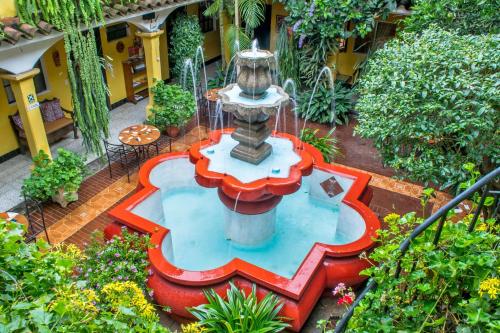 an aerial view of a fountain in a garden at Posada San Vicente by AHS in Antigua Guatemala