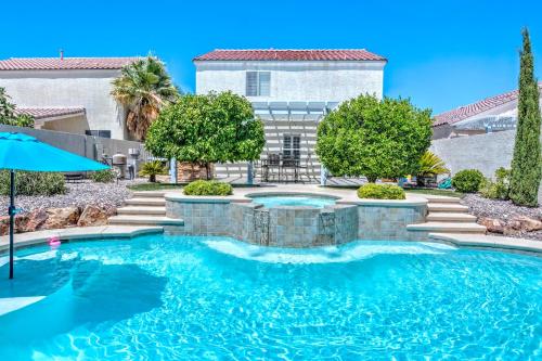 a swimming pool in front of a house at Vegas Vacation in Las Vegas