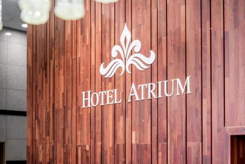 a hotel atrium sign on a wooden wall at Hotel Atrium Jongno in Seoul