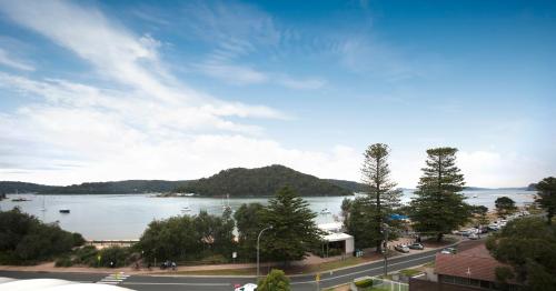a view of a large body of water with a mountain at Ettalong Beach Luxury Apartments in Ettalong Beach