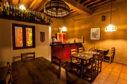 a dining room with a table and a bar at Posada Yolihuani in Pátzcuaro