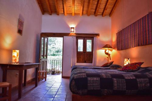 a bedroom with a bed in a room with a window at Posada Yolihuani in Pátzcuaro