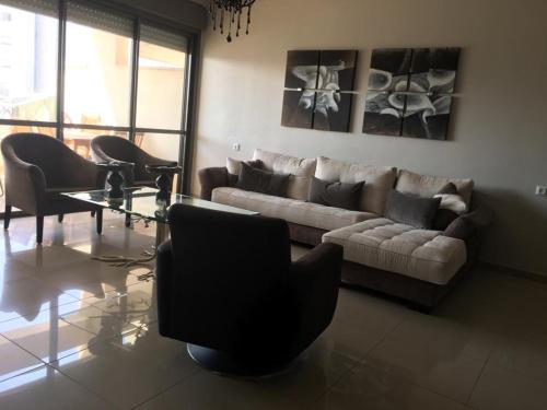 a living room with a couch and chairs and a table at Apartment 2 bedrooms Central Location in Ashdod