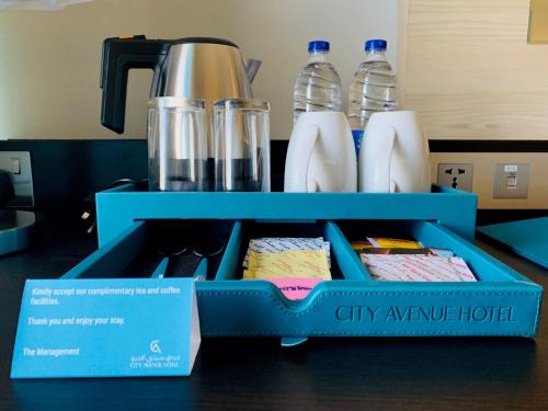 a blue lunch box with some food in it at City Avenue Hotel in Dubai