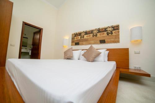 a bedroom with a large white bed in a room at The ONE in Watamu