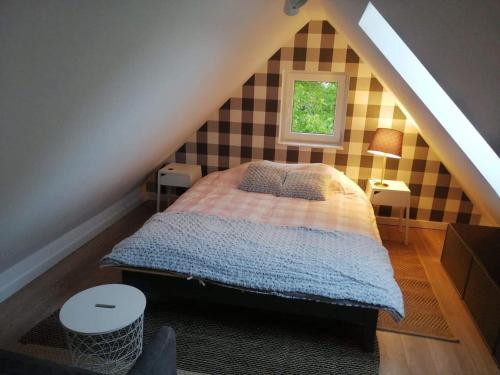 a bedroom with a bed in a attic at Dom na Kaszubach in Kościerzyna