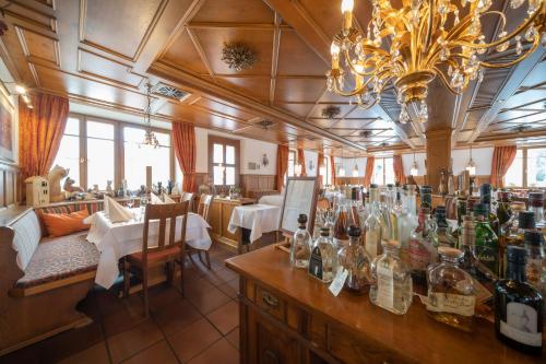 a restaurant with a bar with bottles of wine at Hotel Hirsch in Kehl am Rhein