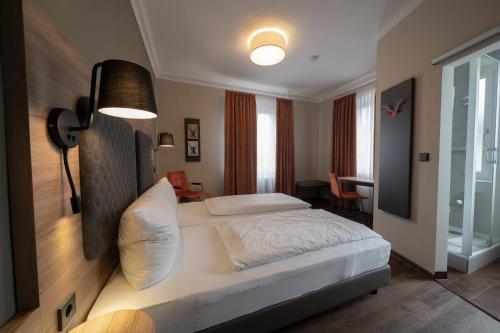 a bedroom with a large bed in a room at Hotel Hirsch in Kehl am Rhein