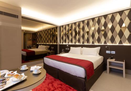 a hotel room with a bed and a table with plates of food at Harry's Bar Trevi Hotel & Restaurant in Rome