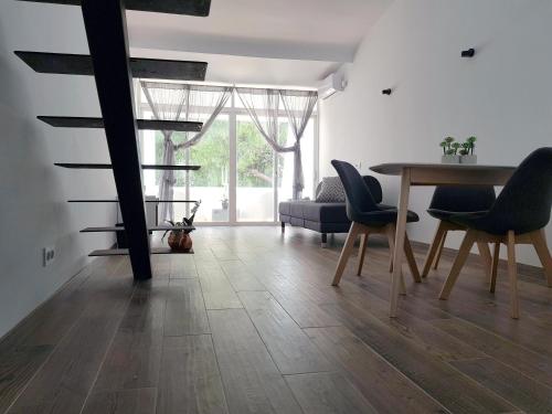 a living room with a dining room table and chairs at Lugar de la Luz in Estepona