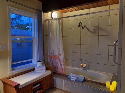 a bathroom with a tub and a sink and a window at Wheeler on the Bay Lodge and Marina in Wheeler