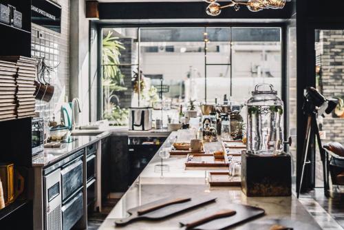 a kitchen with a long counter with knives and a table at PAPO'A Hotel in Kaohsiung