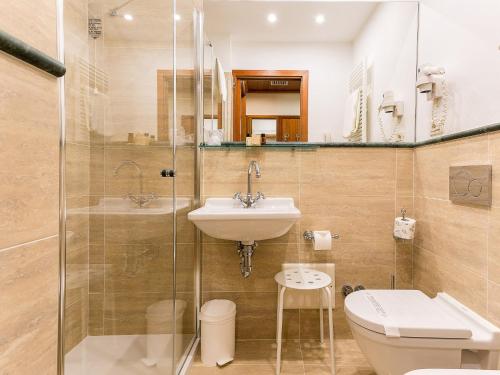 a bathroom with a sink and a toilet and a shower at Hotel Continental in Santa Margherita Ligure