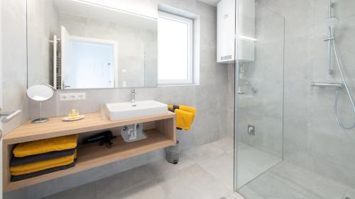 a bathroom with a sink and a shower at Apartments Jesse in Sankt Kanzian