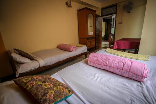 a room with two beds with pillows on them at Golden Gate Guest House in Bhaktapur