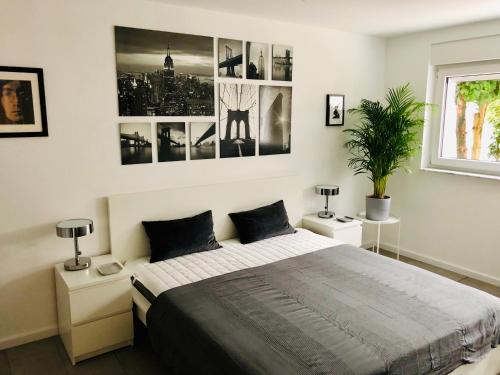 a bedroom with a large bed with two night stands at Leverkusen Schlebusch Ferienhaus in Leverkusen