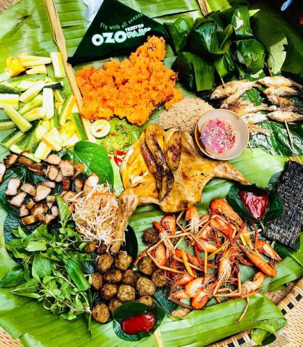 a plate of food with vegetables and other foods at Peaceful House Hostel in Dong Hoi