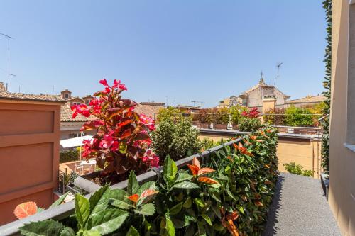 a balcony with flowers and plants on a building at Harry's Bar Trevi Hotel & Restaurant in Rome
