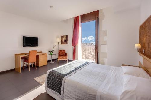Postel nebo postele na pokoji v ubytování Grande Albergo Alfeo