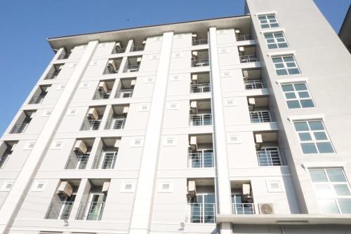 a white building with many windows at JVAPLACE in Nonthaburi
