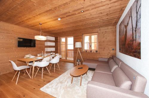 a living room with a couch and a table at Alpin Chalet Schröcken in Schröcken
