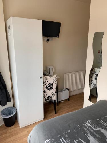 a room with a bed and a white door at Alandene in Blackpool