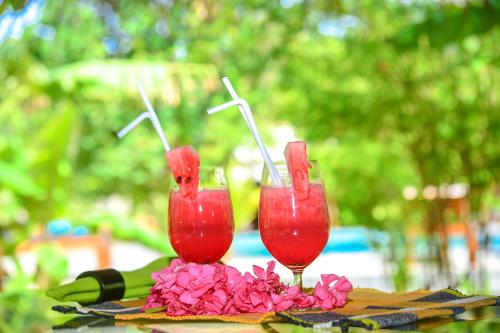 two glasses of red drinks sitting on a table at Richards Cabanas in Tissamaharama