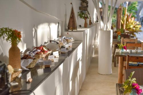 a room with a counter with vases and plants at Indigo Beach Zanzibar in Bwejuu