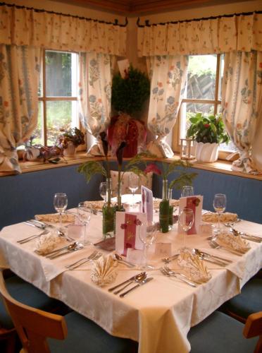 a table with a white table cloth on it at Pension Steinerhof in Oberau