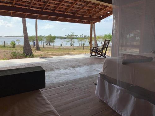 a bedroom with a bed and a view of the water at Kitelantis Hotel and Resort in Kalpitiya