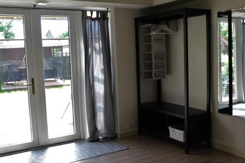 a living room with a mirror and a glass door at Sigulda City Center Holiday House in Sigulda