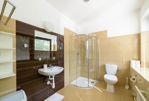 a bathroom with a shower toilet and a sink at Sopocki Zdrój Apartments in Sopot