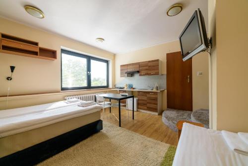 a room with a bed and a desk and a tv at Sopocki Zdrój Apartments in Sopot