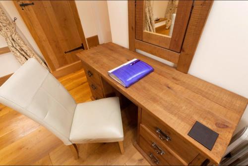 a desk with a chair and a blue folder on it at Hanger Down House Bed and Breakfast in Arundel