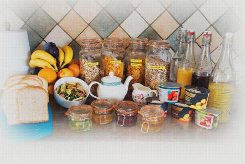 a counter with jars of food and a bunch of fruit at Kingstown House in Cashel